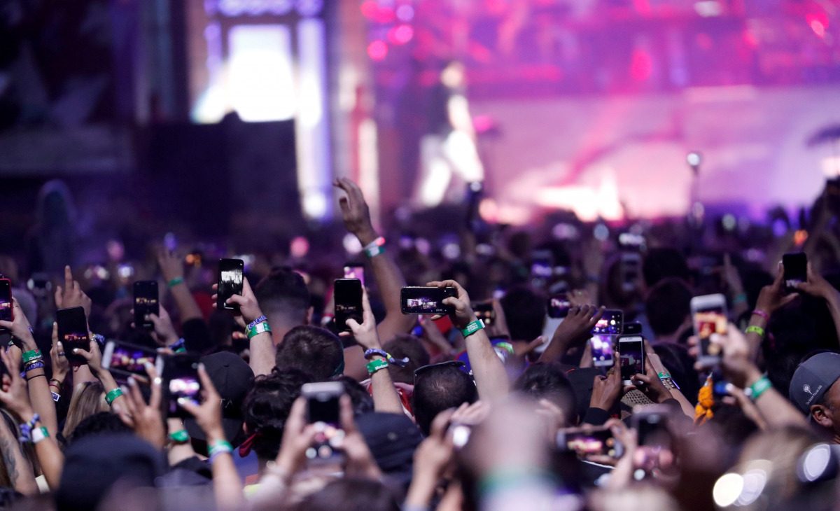 FILE PHOTO: Concertgoers use their mobile phones during Eminem's performance at the Coachella Valley Music and Arts Festival in Indio, California, U.S., April 15, 2018. REUTERS/Mario Anzuoni/File Photo

