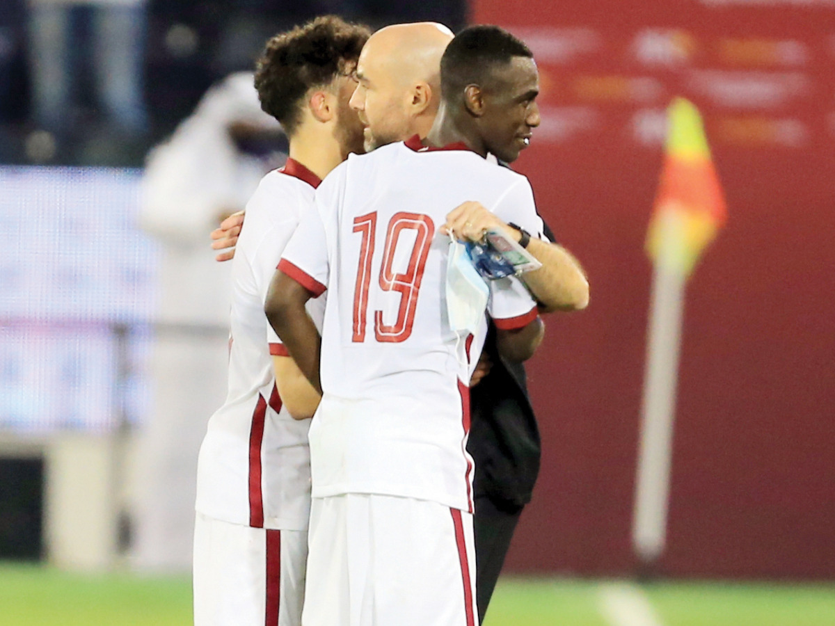 Coach Felix Sanchez celebrates with Almoez Ali and Bassam Al Rawi after the match. Pic: Hussain Sayed