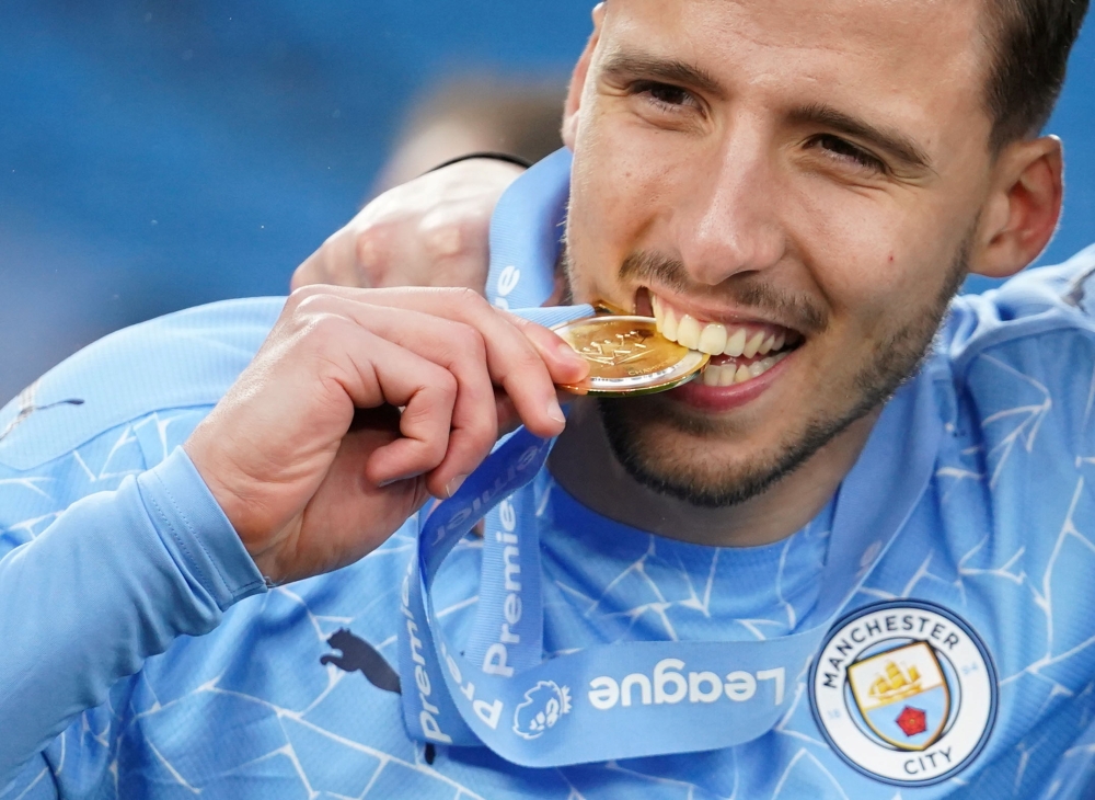 Manchester City's Ruben Dias celebrates with his medal after winning the Premier League Pool via REUTERS/Dave Thompson 