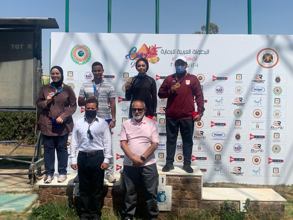 Qatar's Rashid Saleh Al Athba and Reem Al Sharshani with other podium winners and officials after winning the gold medal in the mixed skeet competition during the Arab Shooting Championship in Cairo, Egypt, yesterday.
