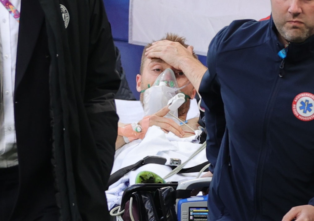 Denmark's Christian Eriksen is carried off after collapsing during the match Pool via REUTERS/Friedemann Vogel