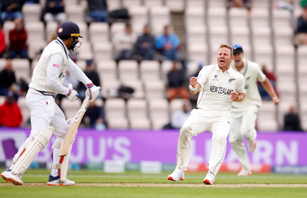  New Zealand's Neil Wagner celebrates taking the wicket of India's Shubman Gill. (Reuters/John Sibley)