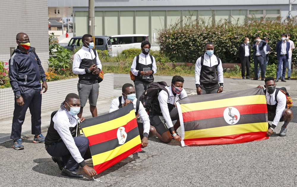 Members of Uganda's Olympic team pose for a photograph upon their arrival at their pre-Olympics camp host town Izumisano, after a member of their team has tested positive fo the coronavirus disease (COVID-19) and was barred entry into Japan, in Izumisano,