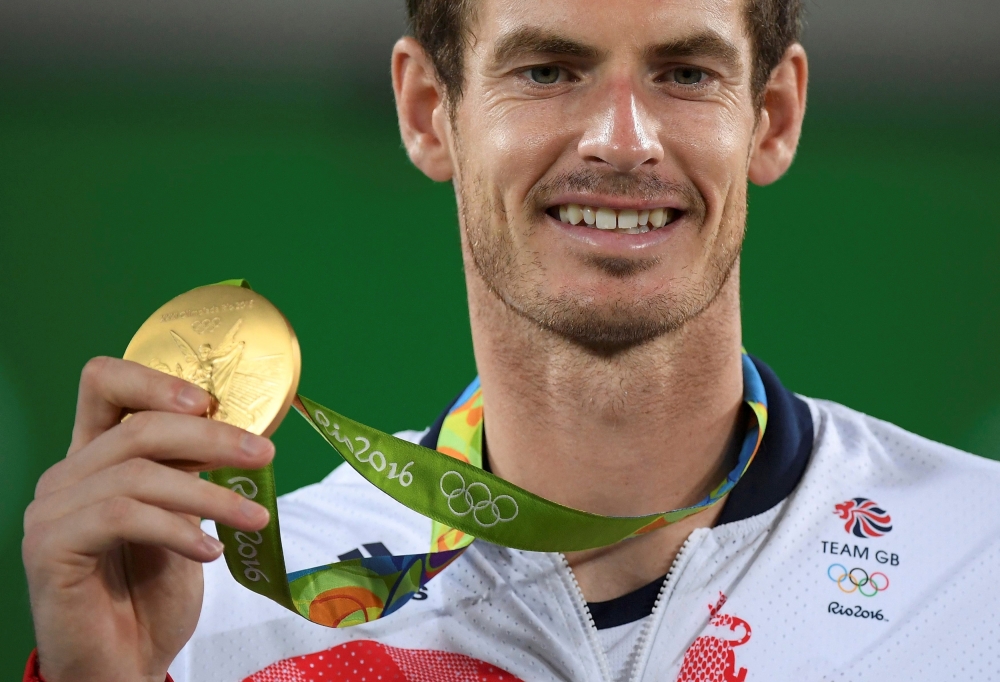 Gold medalist Andy Murray (GBR) of Britain reacts after receiving his medal. REUTERS/Toby Melville
