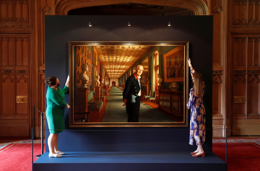 Members of the Royal Collection Trust staff pose for a photograph with the oil on canvas portrait, HRH The Prince Philip, Duke of Edinburgh, 2017, by Ralph Heimans, which forms part of the Prince Philip: A Celebration display in Windsor Castle, Britain, J