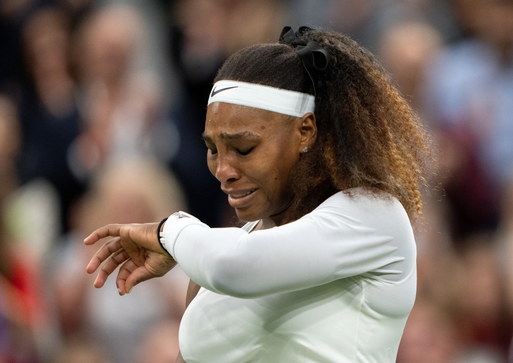 June 29, 2021 Serena Williams of the U.S. reacts after sustaining an injury before retiring from her first round match against Belarus' Aliaksandra Sasnovich Pool via REUTERS/Jed Leicester