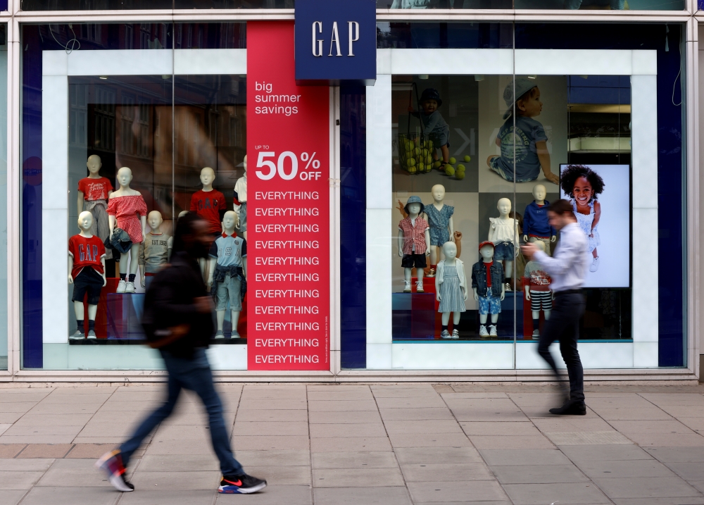 People walk past a Gap store on Oxford Street in London, Britain, July 1, 2021. REUTERS/John Sibley