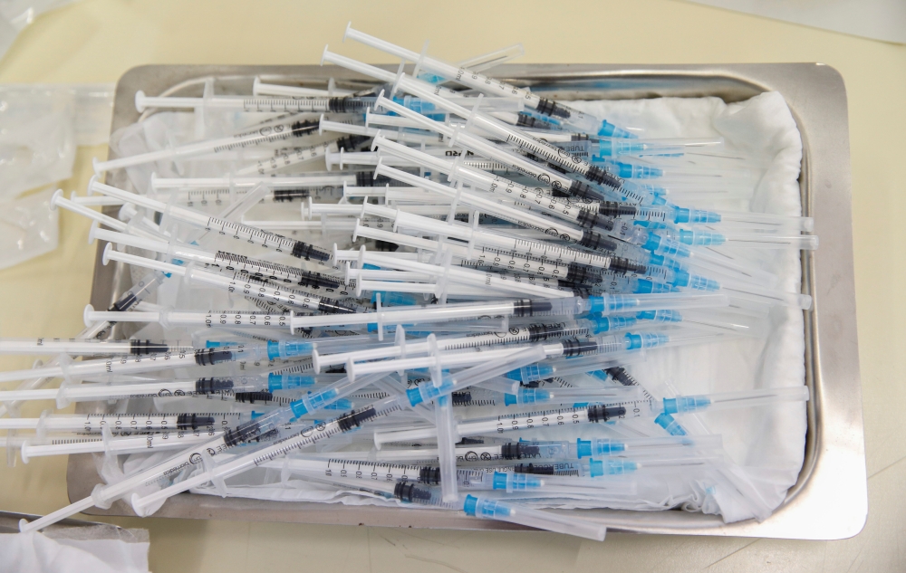 Syringes with the Pfizer-BioNTech vaccines to be administered against the coronavirus disease (COVID-19) lie on a tray during a program without an appointment in Sant Vicenc de Casteller, north of Barcelona, Spain, July 6, 2021. REUTERS/ Albert Gea