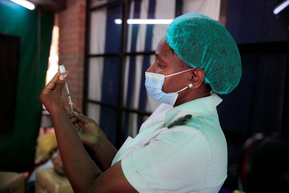 FILE PHOTO: A nurse prepares a dose of the Sinopharm coronavirus disease (COVID-19) vaccine at Wilkins Hospital in Harare, Zimbabwe, March 24, 2021. REUTERS/Philimon Bulawayo/File Photo
