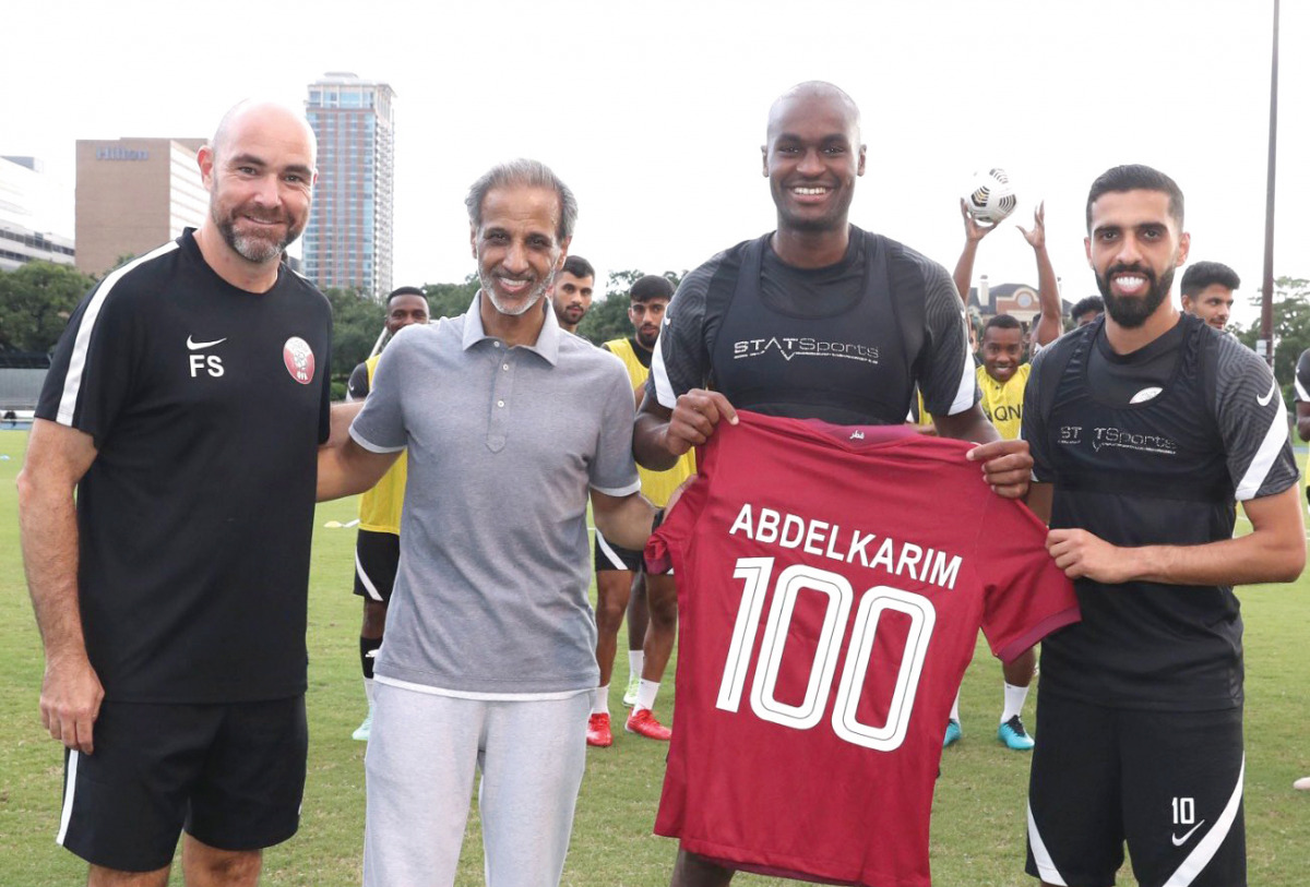 Qatar Football Association President Sheikh Hamad bin Khalifa bin Ahmed Al Thani, coach Felix Sanchez and captain Hassan Al Haydos with Abdelkarim Hassan.