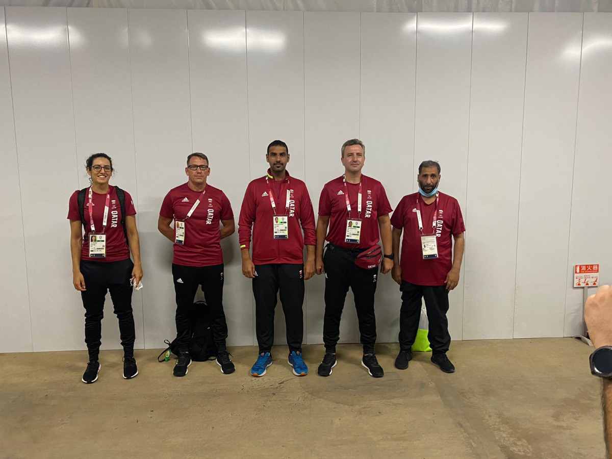 Qatari shooter Muhammad Al Rumaihi (centre), and rower Tala Abujbara pose for a photograph with officials upon their arrival in Tokyo, Japan ahead of the 2020 Olympic Games, yesterday.