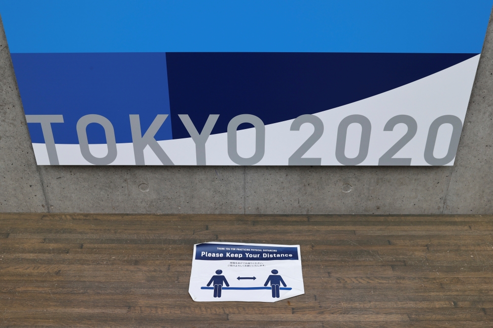 A reminder for social distancing is seen at the Tokyo 2020 Olympic Games Main Press Center during the coronavirus disease (COVID-19) outbreak in Tokyo, Japan, July 16, 2021. REUTERS/Thomas Peter