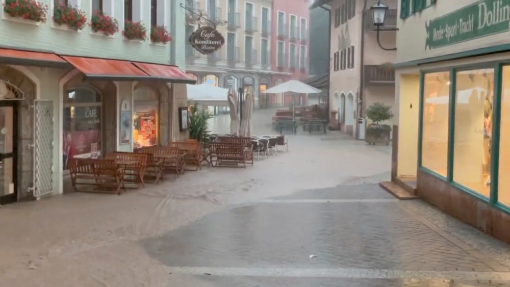 Floodwater runs down the Old Town of Berchtesgaden amid heavy rainfalls in Bavaria, Germany July 17, 2021 in this still image taken from social media video filmed on July 17, 2021. Grillstuberl Berchtesgaden via Facebook/via REUTERS