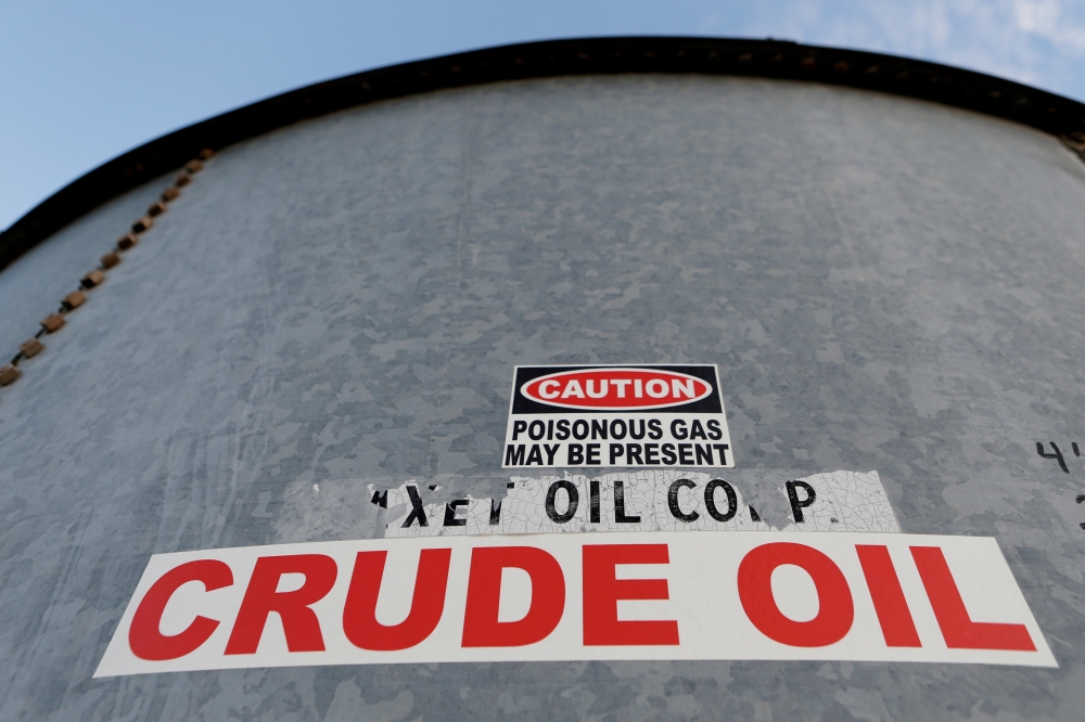 A sticker reads crude oil on the side of a storage tank in the Permian Basin in Mentone, Loving County, Texas, U.S. November 22, 2019. REUTERS/Angus Mordant/File Photo
 