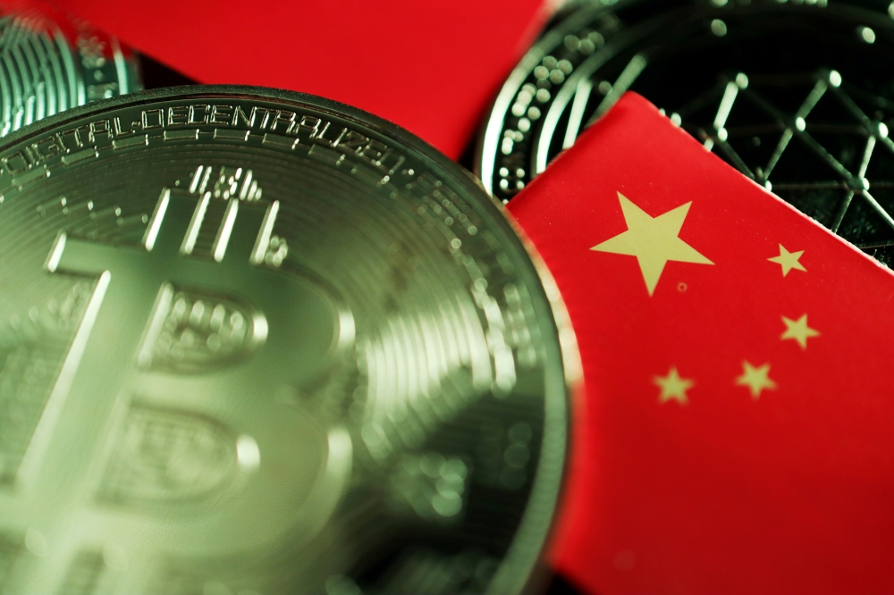 A Chinese flag is seen among representations of Bitcoin and other cryptocurrencies in this illustration picture. (REUTERS/Florence Lo/Illustration/File Photo)