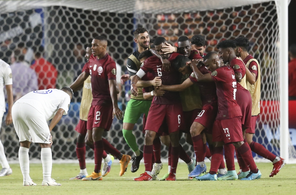 Qatar midfielder Abdelaziz Hatim (6) celebrates his goal with teammates against Honduras in the second half during a CONCACAF Gold Cup group stage soccer match at BBVA Stadium.   Thomas Shea
