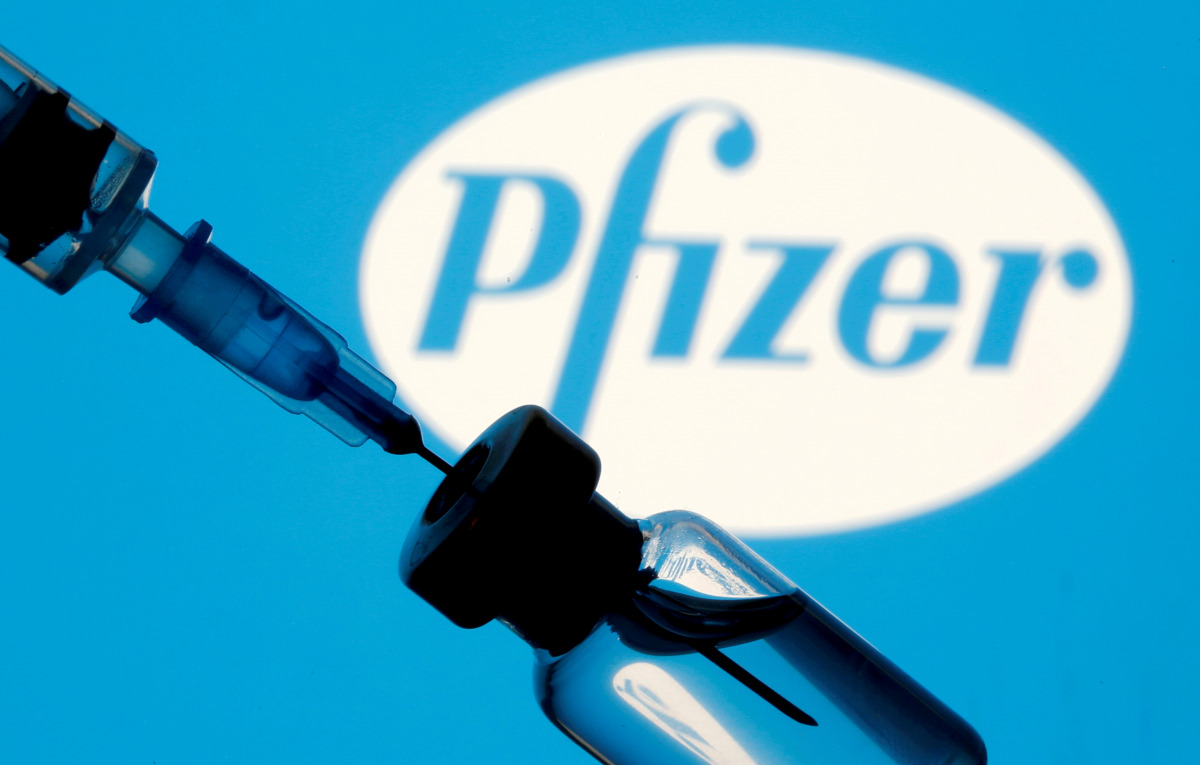 FILE PHOTO: A vial and syringe are seen in front of a displayed Pfizer logo in this illustration taken January 11, 2021. REUTERS/Dado Ruvic/Illustration/File Photo

