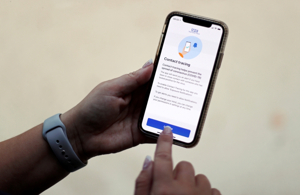 The coronavirus disease (COVID-19) contact tracing smartphone app of Britain's National Health Service (NHS) is displayed on an iPhone in this illustration photograph taken in Keele, Britain, September 24, 2020. REUTERS/Carl Recine/Illustration/File Photo