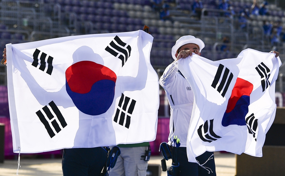 July 24, 2021. An San of South Korea and Kim Je Deok of South Korea wave their national flags after winning gold REUTERS/Clodagh Kilcoyne