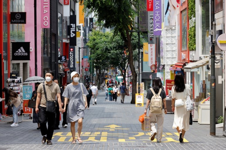 People wearing masks walk in a shopping district amid the coronavirus disease (COVID-19) pandemic in Seoul, South Korea, July 9, 2021. REUTERS/ Heo Ran