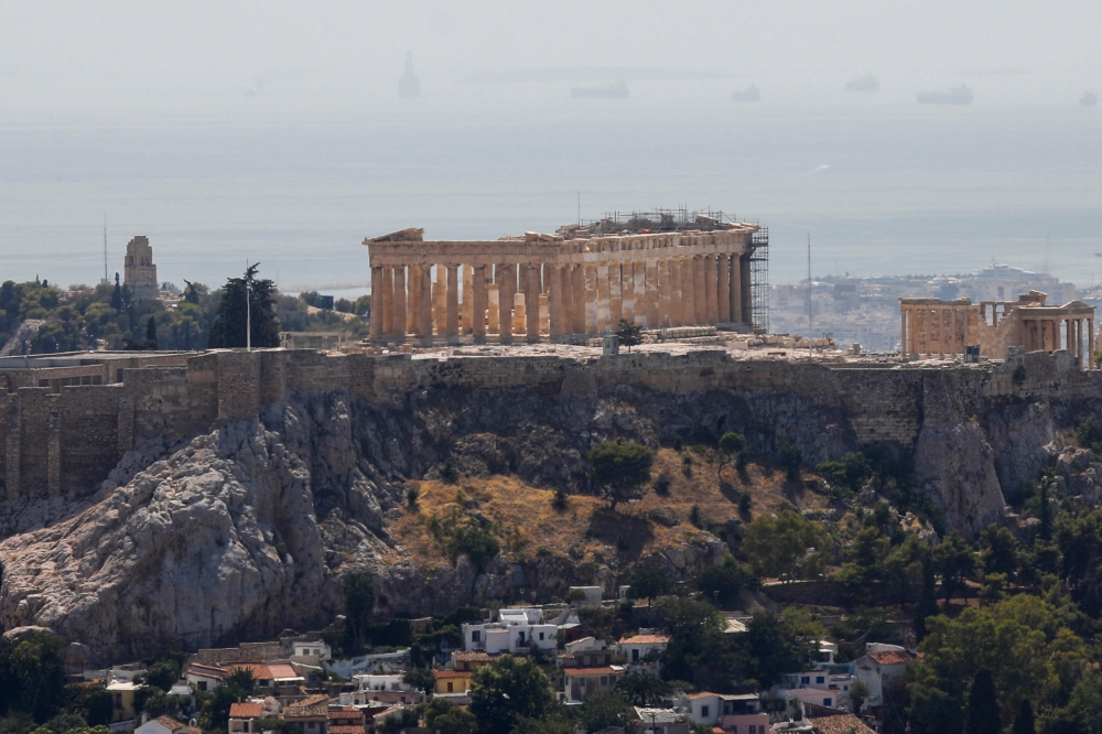 The Parthenon temple is seen atop the empty Acropolis hill archaeological site, closed to the public during a heatwave in Athens, Greece, July 30, 2021. REUTERS/Costas Baltas