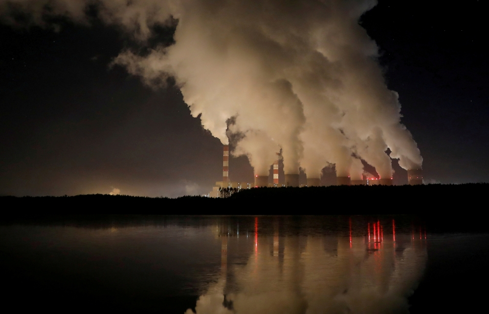 Smoke and steam billows from Belchatow Power Station, Europe's largest coal-fired power plant operated by PGE Group, at night near Belchatow, Poland December 5, 2018. REUTERS/Kacper Pempel/File Photo