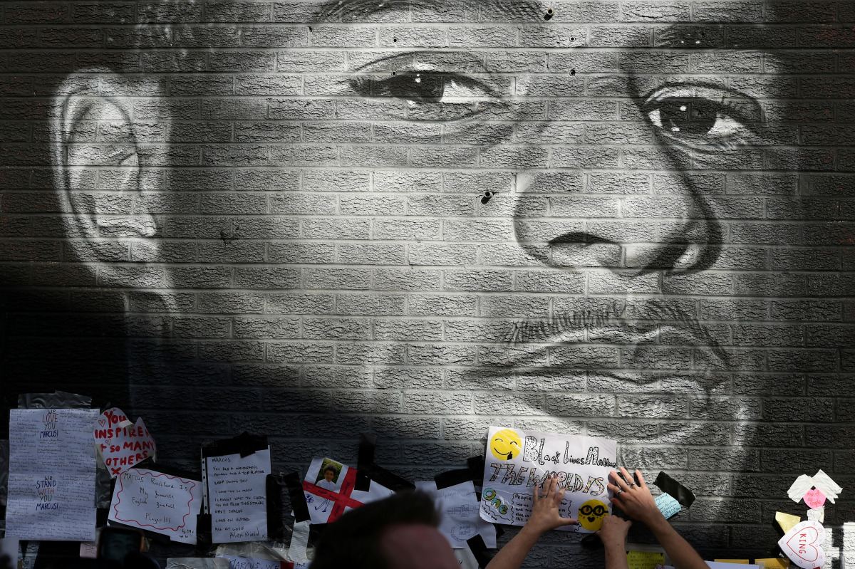 FILE PHOTO: Stand Up to Racism Demonstration at the Marcus Rashford mural after it was defaced following the Euro 2020 Final between Italy and England - Withington, Manchester, Britain - July 13, 2021. REUTERS/Peter Powell/File Photo
