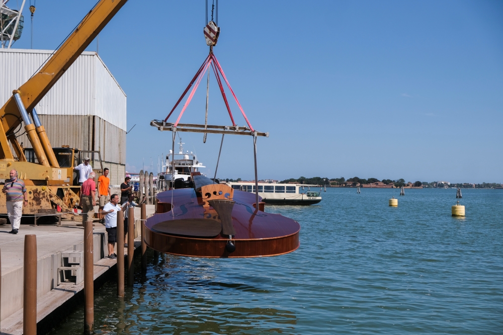 A boat in the shape of a violin, titled 'Violin of Noah', built during the pandemic by artist Livio De Marchi in collaboration with Consorzio Venezia Sviluppo and is dedicated to people who have died from coronavirus, is seen during a test-ride, in Venice