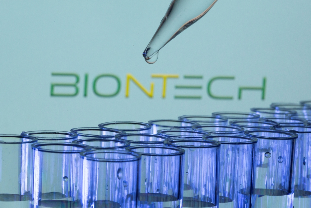 Test tubes are seen in front of a displayed Biontech logo in this illustration taken, May 21, 2021. REUTERS/Dado Ruvic/Illustration/File Photo