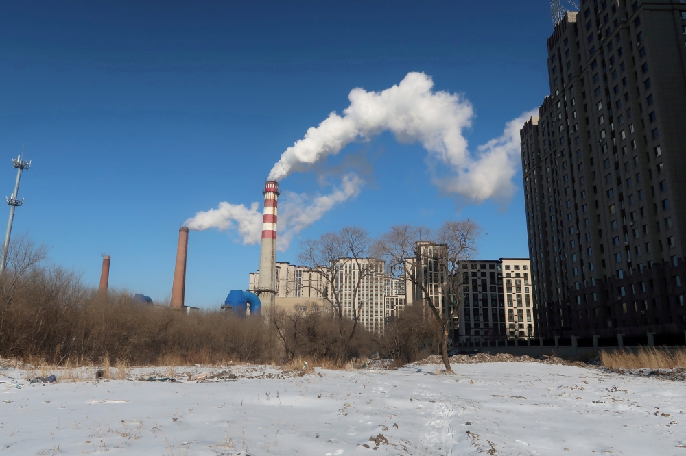 A coal-fired heating complex is seen behind the ground covered by snow in Harbin, Heilongjiang province, China November 15, 2019. Picture taken November 15, 2019. REUTERS/Muyu Xu//File Photo