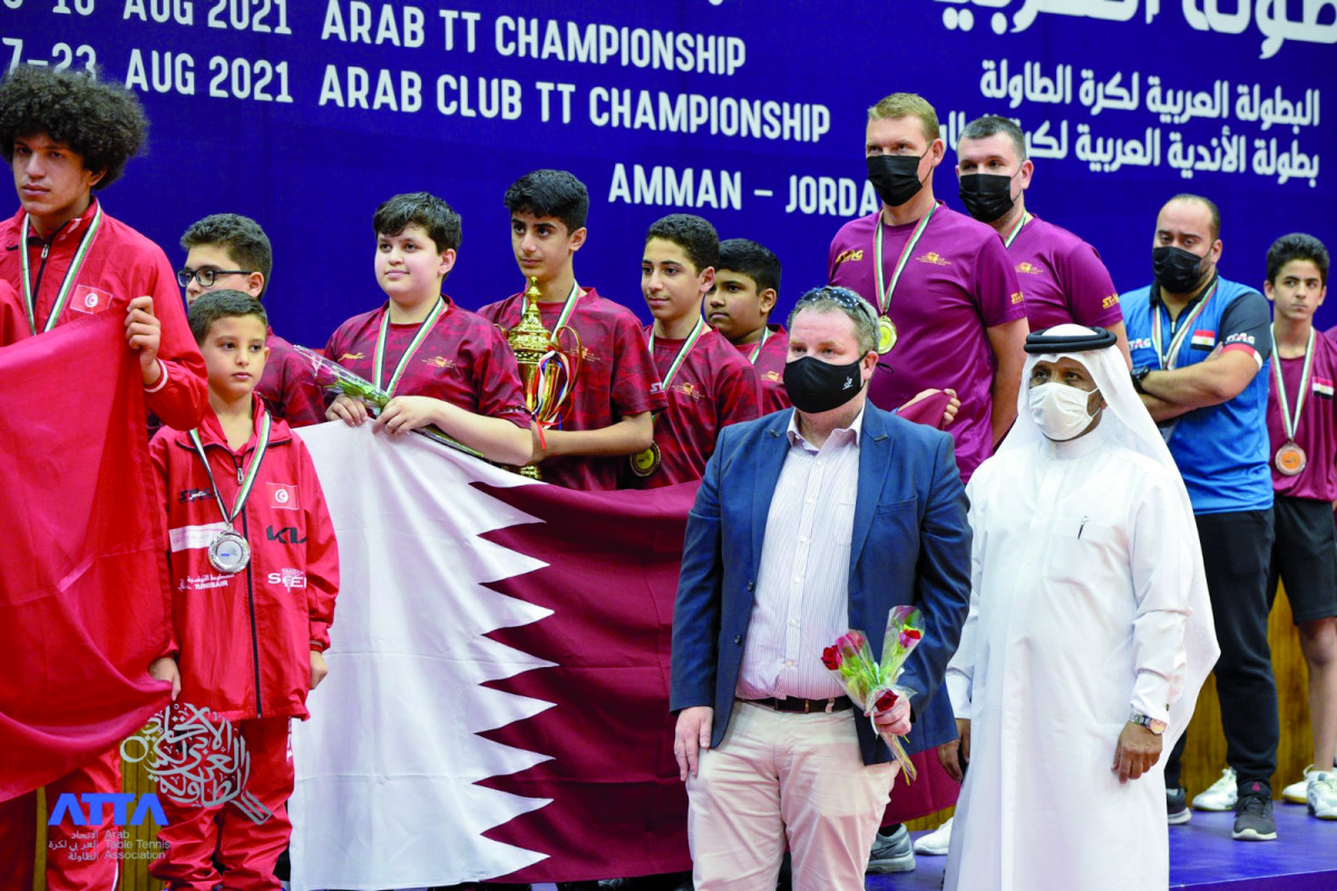 Khalil Ahmad Al Mohannadi, President of the Arab Table Tennis Federation and Qatar Table Tennis Association and First Vice-President of the International Table Tennis Federation, poses for a photograph with an official and the Qatar U-13 team members and 