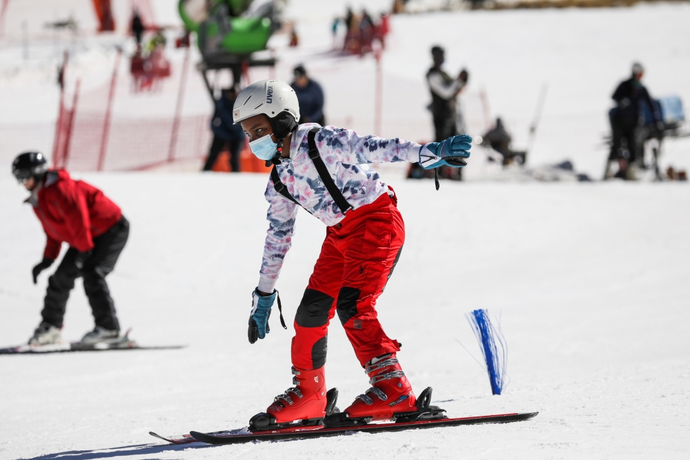 A young skier tries to stay upright during a ski lesson with Hope Ramokotjo at Kapoko Snow Park at Afriski Mountain Resort in Butha Buthe, Lesotho, July 31, 2021. Picture taken July 31, 2021. REUTERS/Sumaya Hisham