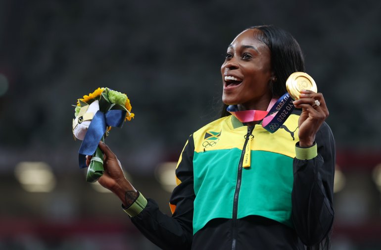 August 4, 2021. Gold medallist Elaine Thompson-Herah of Jamaica celebrates on the podium REUTERS/Lindsey Wasson
