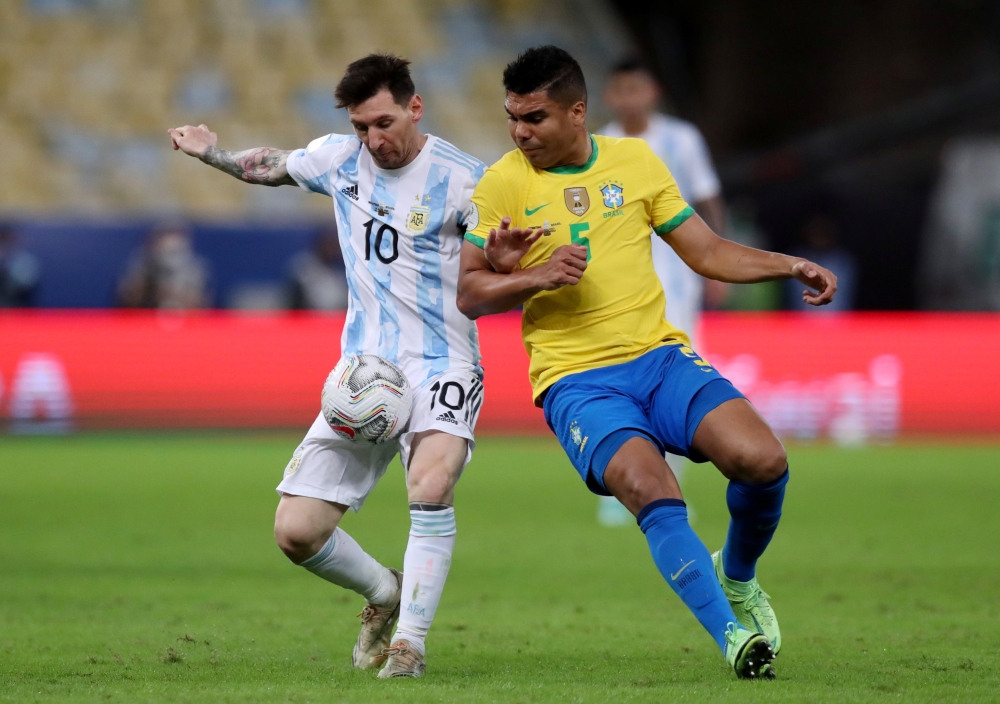 July 10, 2021 Brazil's Real Madrid midfielder Casemiro in action with Argentina's Lionel Messi REUTERS/Amanda Perobelli/File Photo