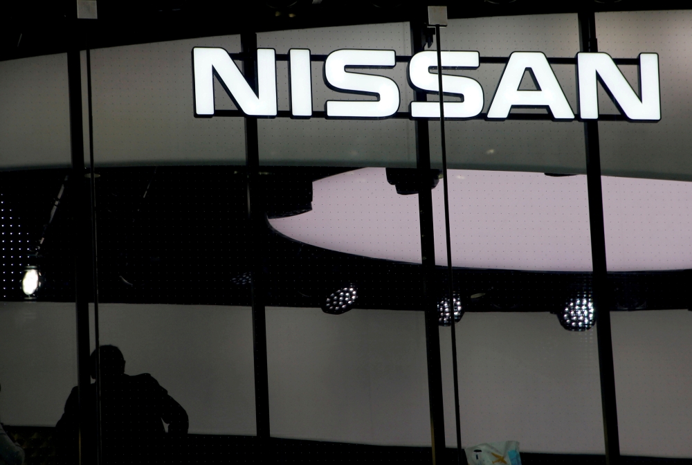 A man is silhouetted at a show room of Nissan Motor Co. in Tokyo, Japan, February 12, 2019. REUTERS/Kim Kyung-hoon/File Photo/File Photo