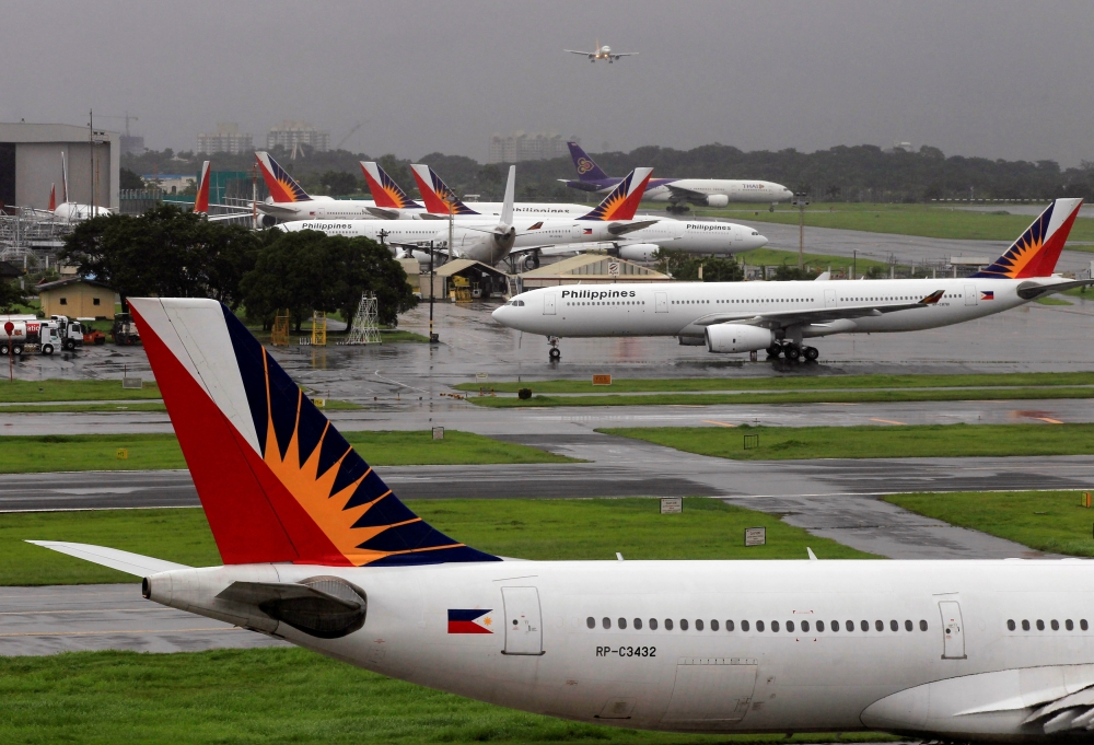 FILE PHOTO: Philippine Airlines (PAL) planes are seen parked on the tarmac in Manila International Airport in Pasay city, metro Manila September 9, 2014. REUTERS/Romeo Ranoco