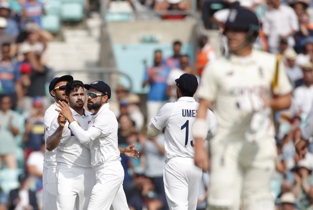 India's Shardul Thakur celebrates taking the wicket of England's Rory Burns with India's Virat Kohli Action Images via Reuters/Andrew Couldridge