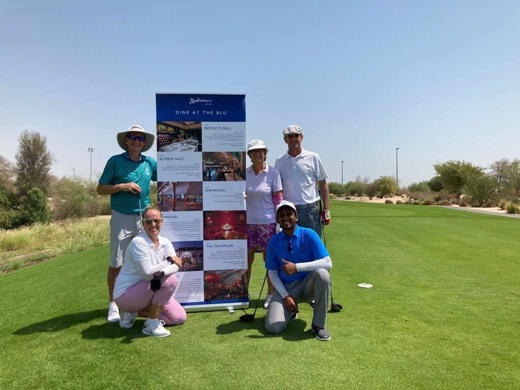 Golfers pose for a group photo after the event.
