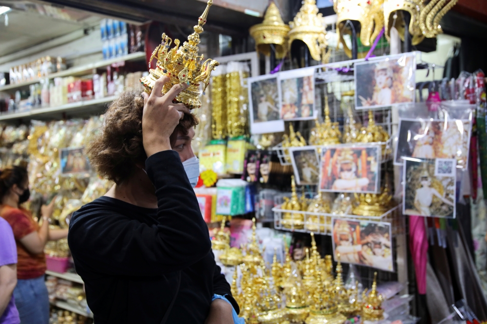 A customer looks for Thai traditional costume head gear similar to one wore by Thai-born K-pop singer Lalisa 