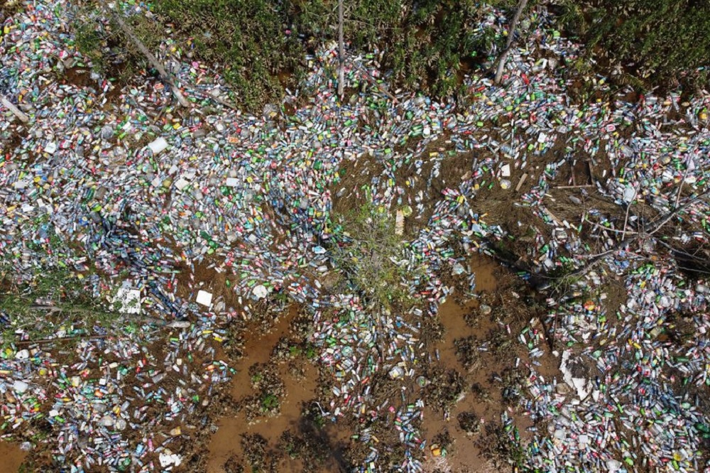 Plastic bottles are seen in a ditch where floodwaters have receded following heavy rainfall in Xinxiang, Henan province, China July 25, 2021. REUTERS/Aly Song