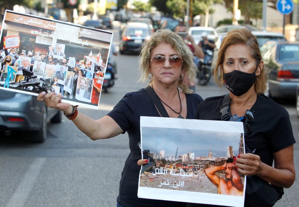 Family members of some of the victims of last year's Beirut port blast, hold pictures ahead of a parliament meeting near UNESCO Palace in Beirut, Lebanon, August 12, 2021. Reuters/Aziz Taher/File Photo