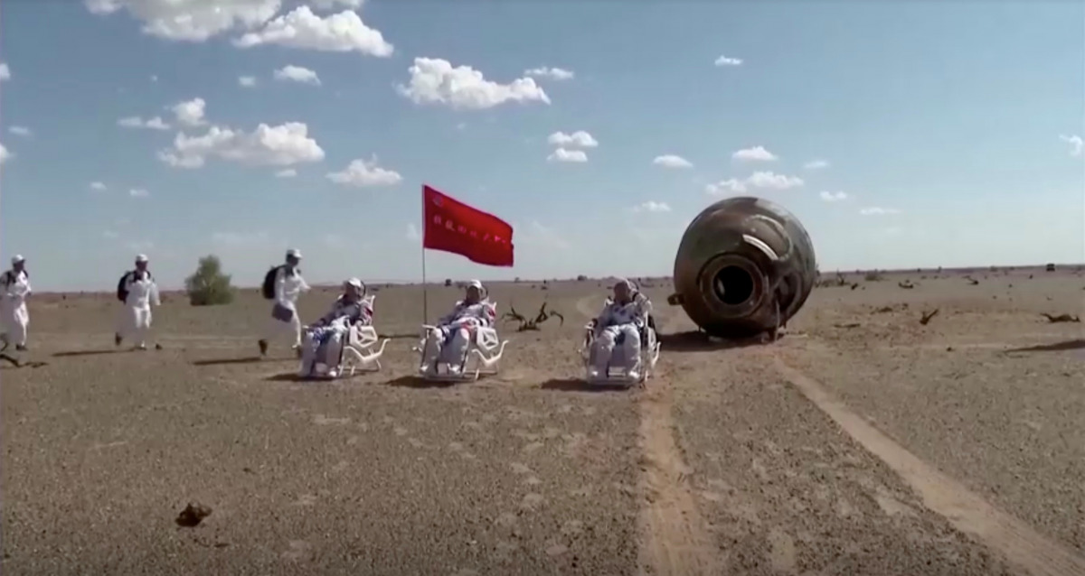 A screen grab shows Chinese astronauts posing for photos after their 90-day mission to a space station, in China's Inner Mongolia Autonomous Region, September 17, 2021. Reuters TV/China Central Television (CCTV) via REUTERS 