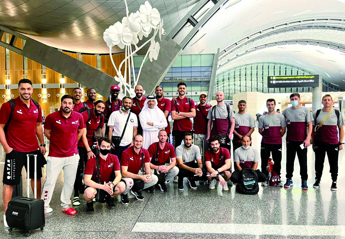 Qatar volleyball players and officials posing for a photograph upon their arrival at the Hamad International Airport in Doha, yesterday.