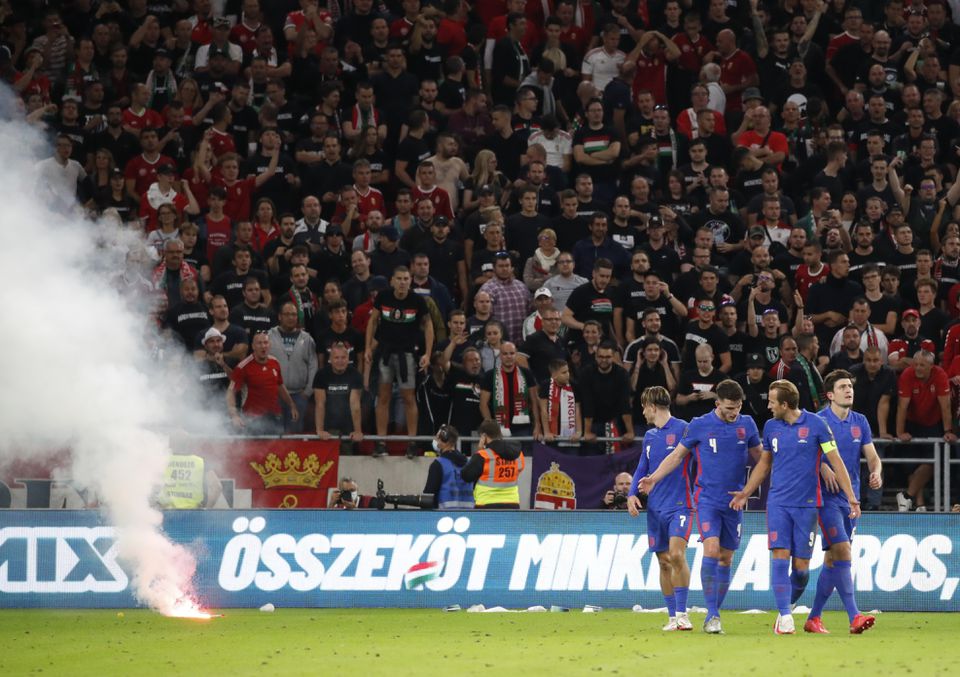 FILE PHOTO: Hungary v England - Puskas Arena, Budapest, Hungary - September 2, 2021 A flare is seen on the pitch as England's Harry Maguire celebrates scoring their third goal with Harry Kane, Declan Rice and Jack Grealish REUTERS/Leonhard Foeger
