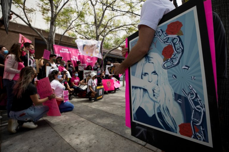 Supporters hold signs during a rally for pop star Britney Spears during a conservatorship case hearing at Stanley Mosk Courthouse in Los Angeles, California, U.S., April 27, 2021. REUTERS/Mario Anzuoni TPX IMAGES OF THE DAY
