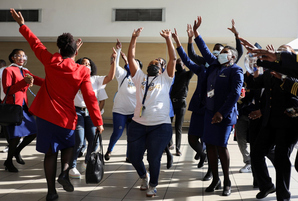 Workers sing and dance as South Africa's national airline, South African Airways (SAA), prepares to take off after a year-long hiatus triggered by it running out of funds, at O.R. Tambo International Airport in Johannesburg, South Africa, September 23, 20