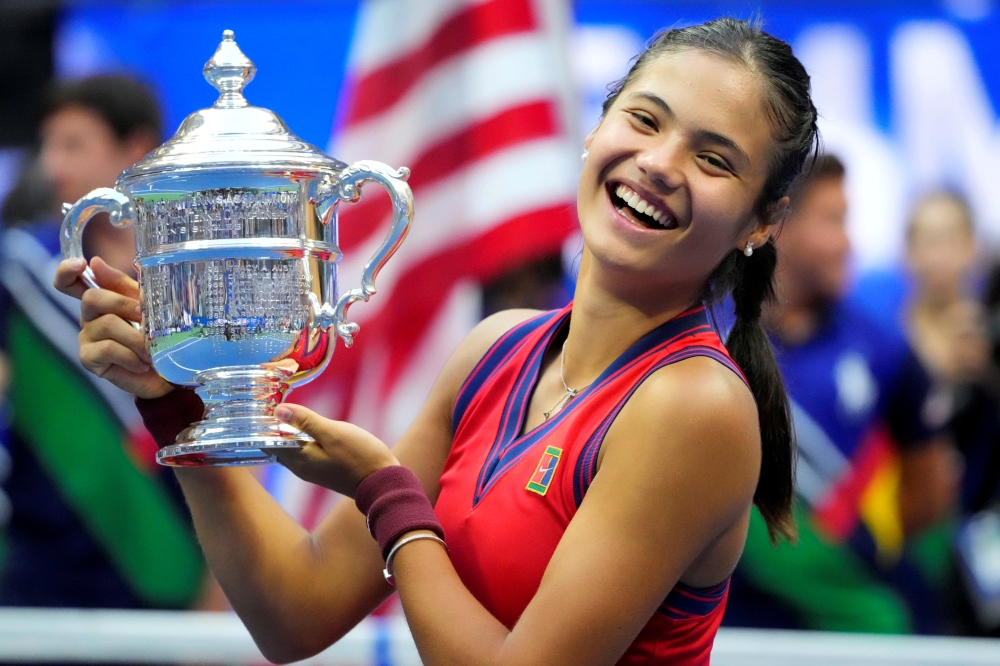 Emma Raducanu of Great Britain celebrates with the championship trophy after her match against Leylah Fernandez of Canada in the women's singles final on day thirteen of the 2021 U.S. Open tennis tournament at USTA Billie Jean King National Tennis Center.