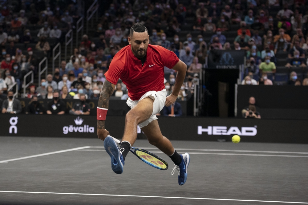Team World player Nick Kyrgios attempts a shot between his legs during the first set of his match against Team Europe player Stefanos Tsitsipas at TD Garden. Richard Cashin-USA Today Sports