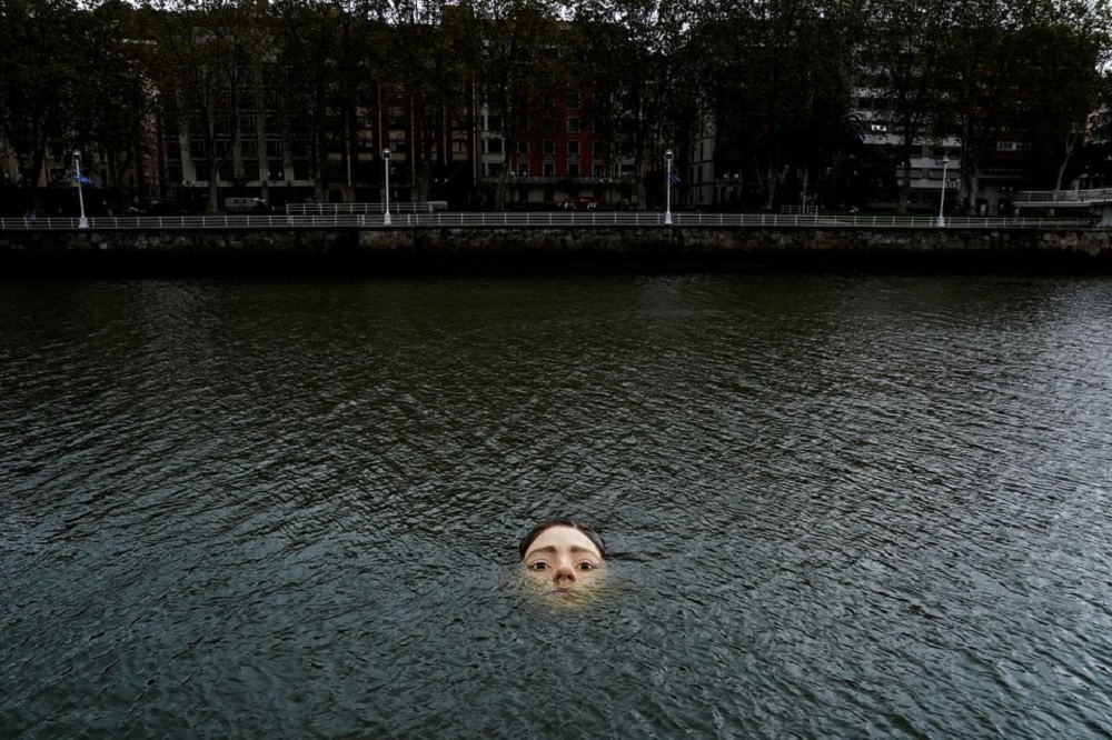 A fibreglass sculpture entitled 'Bihar' (Tomorrow in Basque), by Mexican hyperrealist artist Ruben Orozco, is submerged in the Nervion river in Bilbao, Spain, September 27, 2021. REUTERS/Vincent West TPX IMAGES OF THE DAY