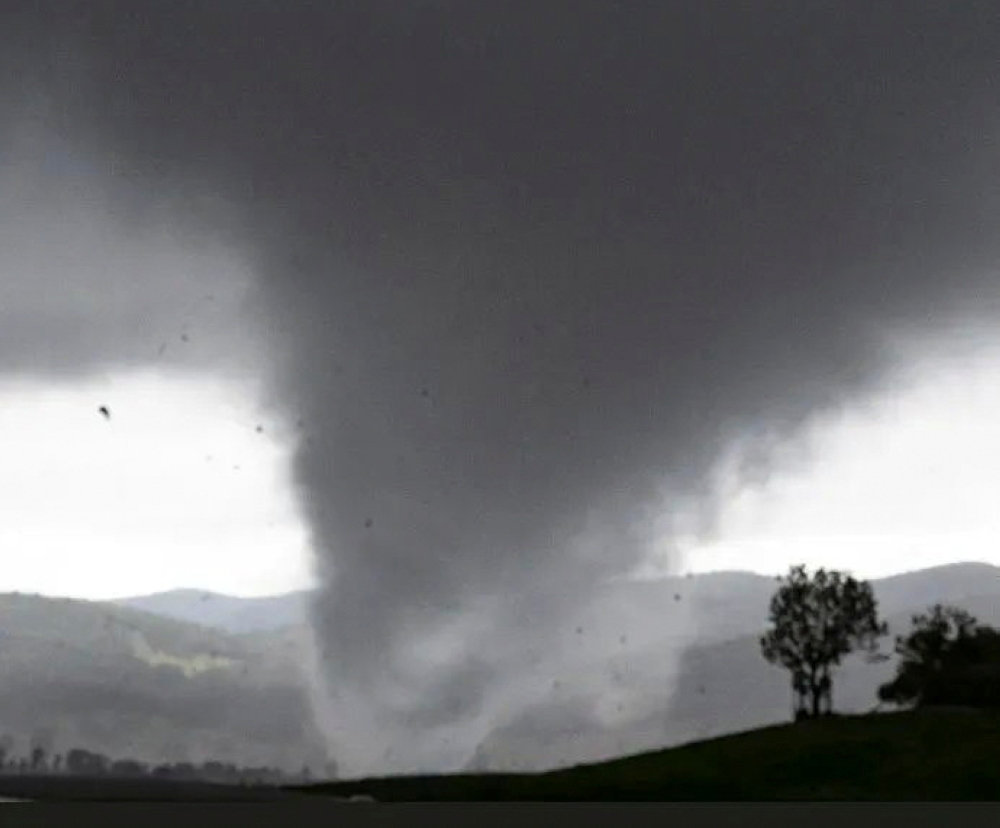 Debris fly around a tornado funnel in Bathurst, New South Wales, Australia September 30, 2021. Dean Whiting via REUTERS